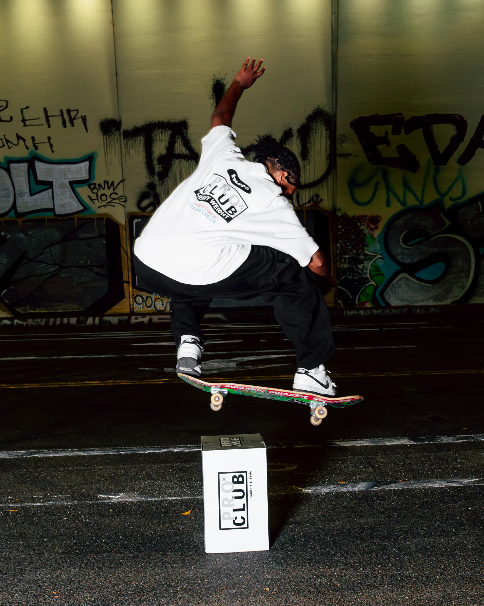 men in proclub X HUF tee & pant doing skates on proclub box
