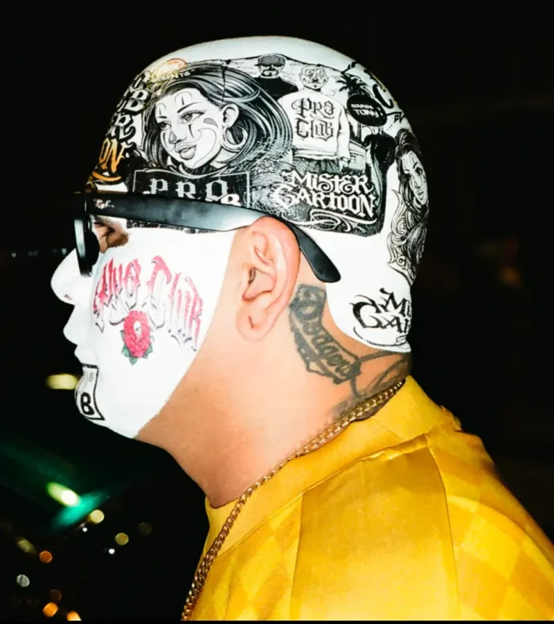 Close-up of Mister Cartoon with head and face tattoos wearing Pro Club