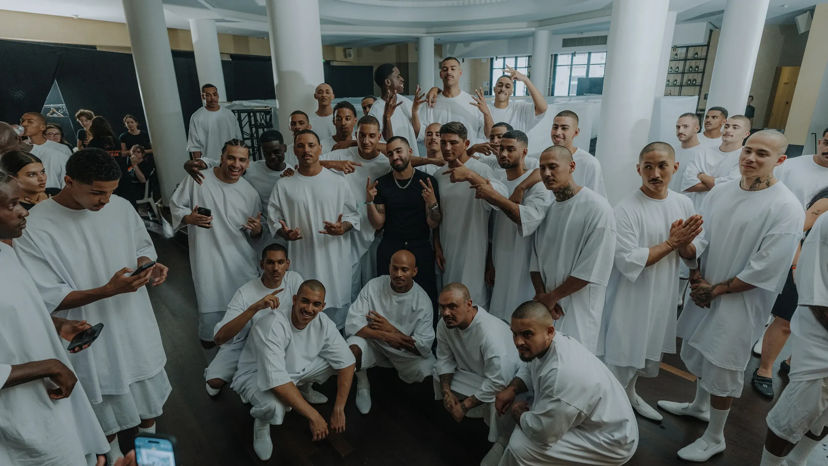 Group of men in white Pro Club tees — the uniform of Los Angeles