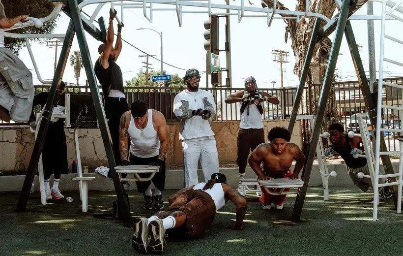 Men working out on outdoor gym bars at a Pro Club Sessions set