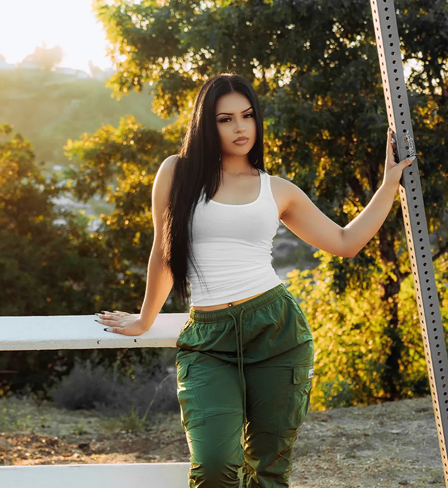 Woman in a white tank top and green cargo pants - shop women's best sellers