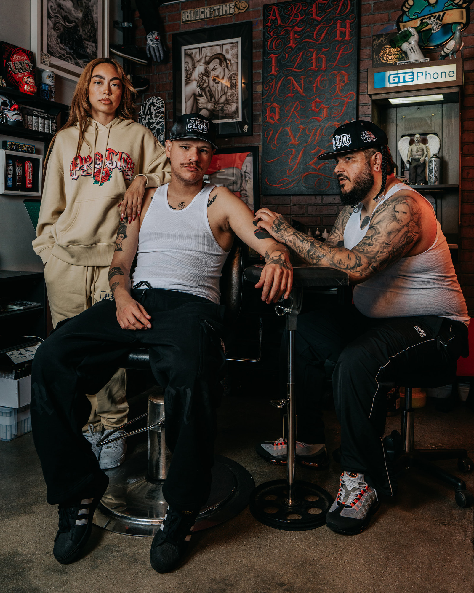 men in mister cartoon x proclub tee in tattoo shop