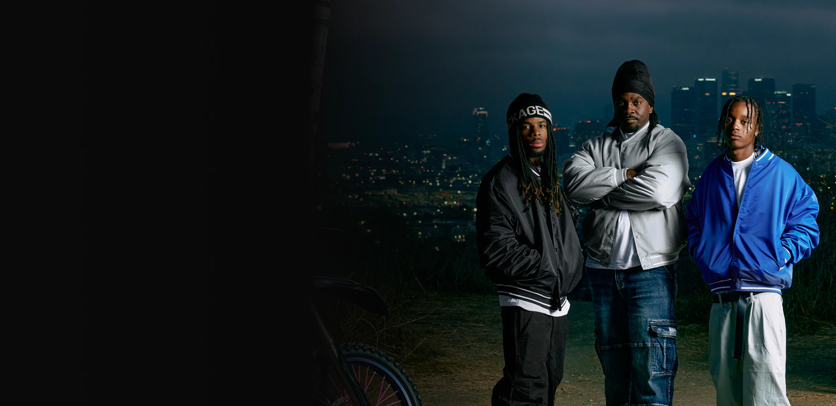 Three people in Pro Club jackets above the Los Angeles skyline at night - Pro Club Rewards
